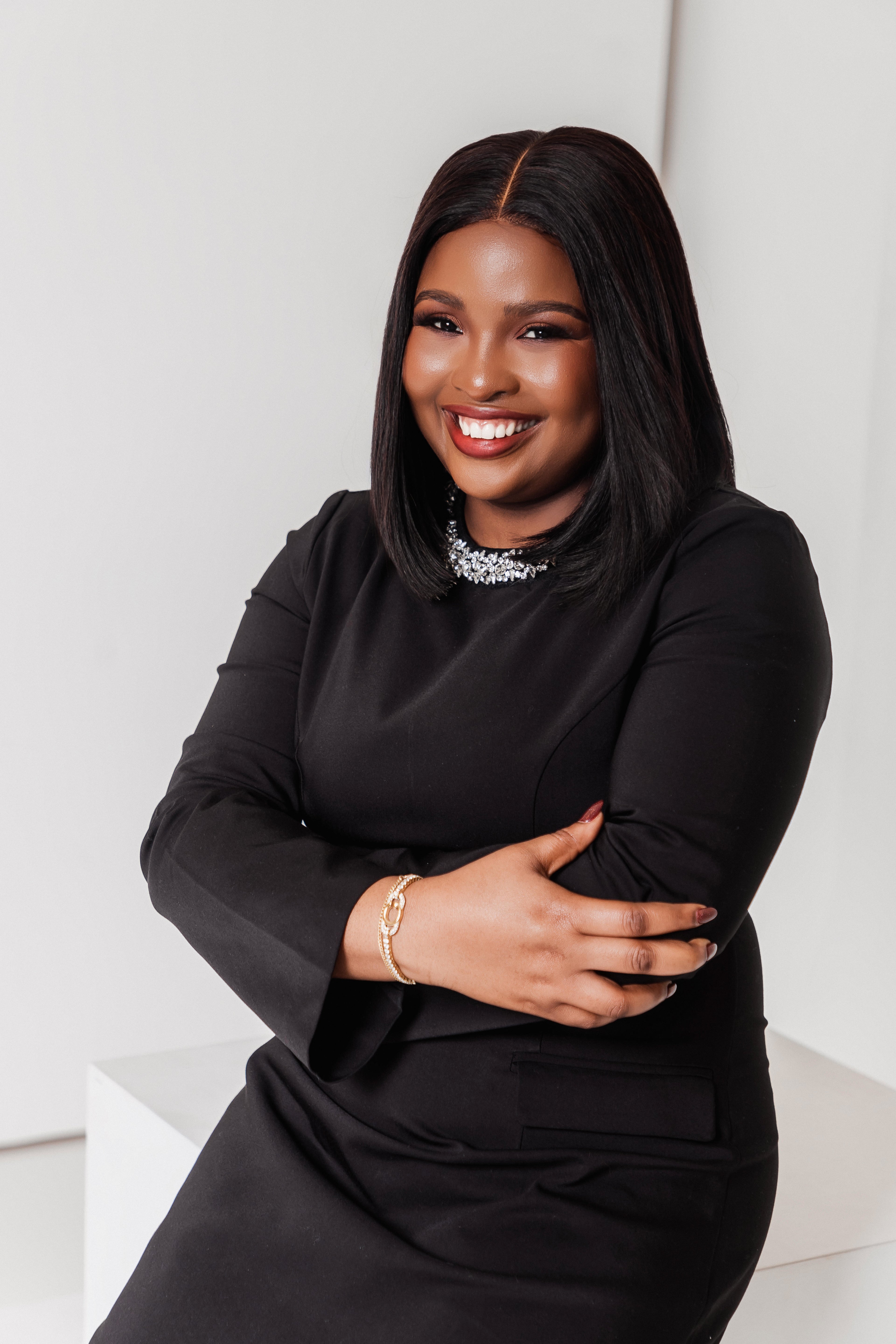 Woman in a black outfit with a white background