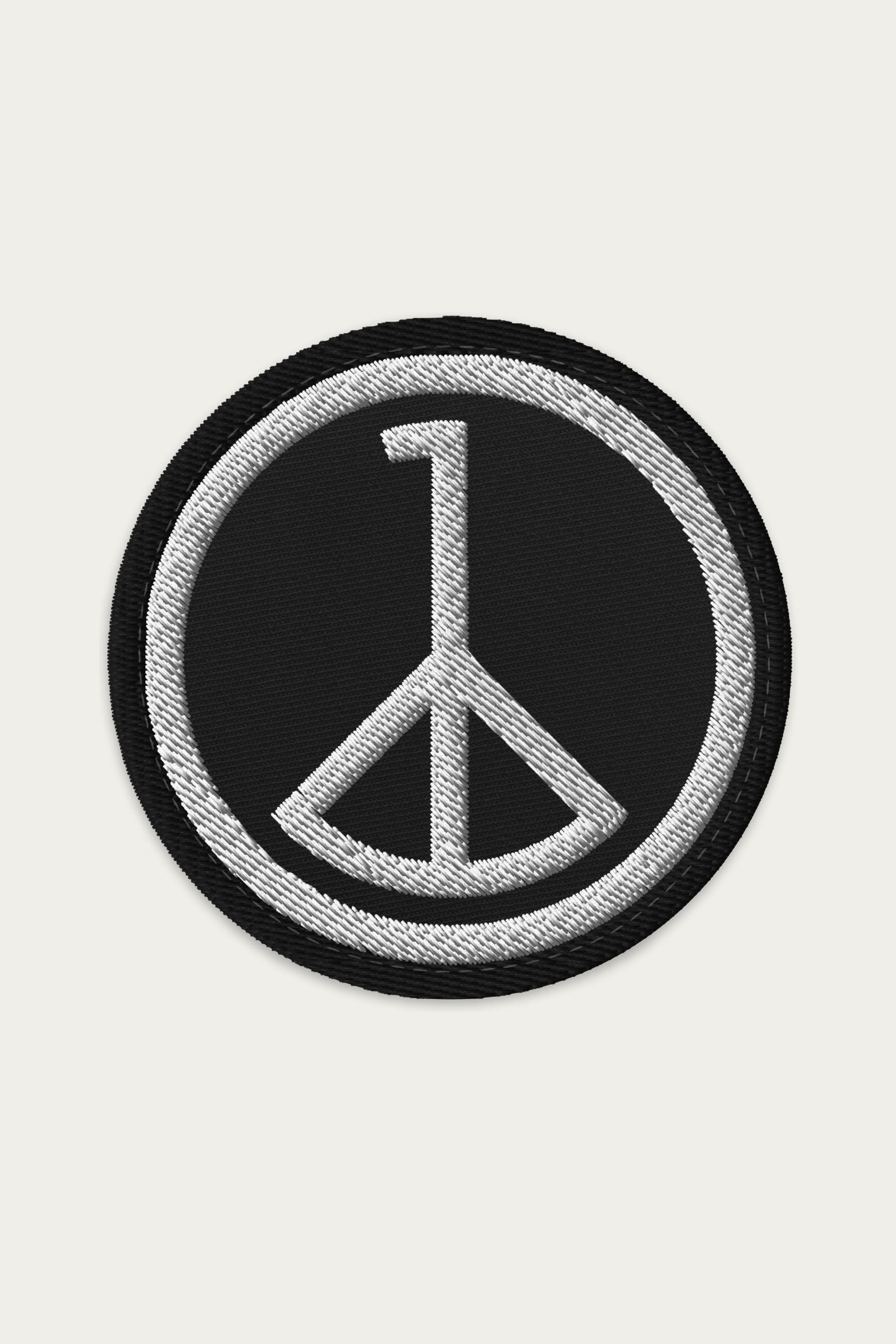 Embroidered Patch, Black by Andre Blunt, shown on a Cloud White ground