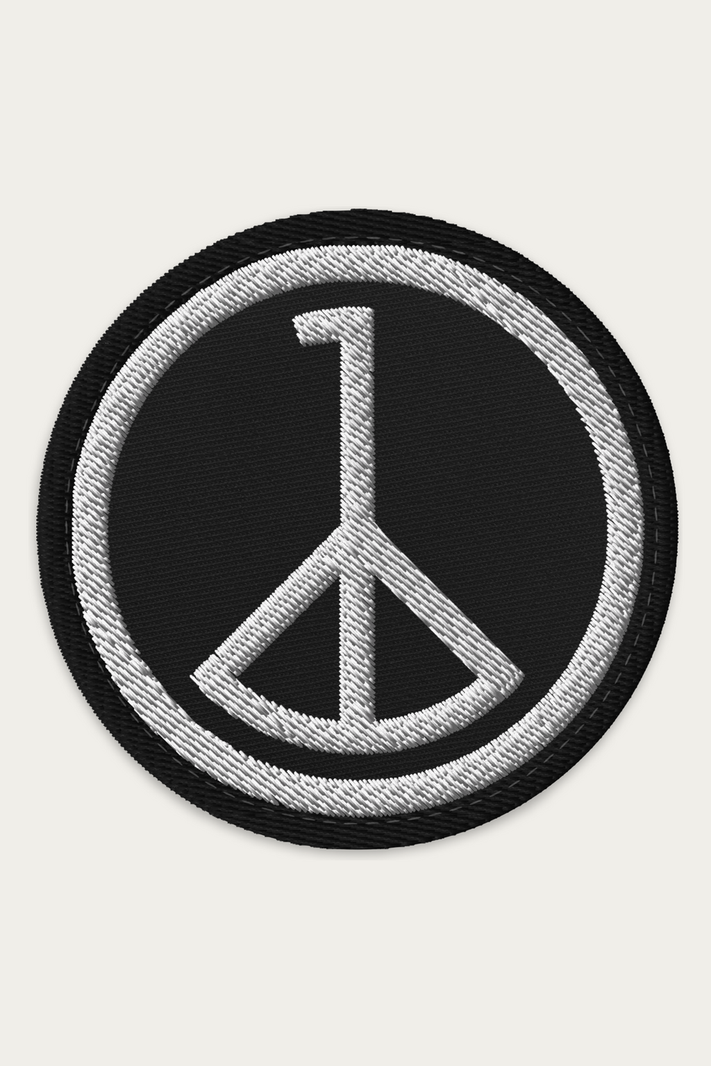 Embroidered Patch, Black by Andre Blunt, shown on a Cloud White ground