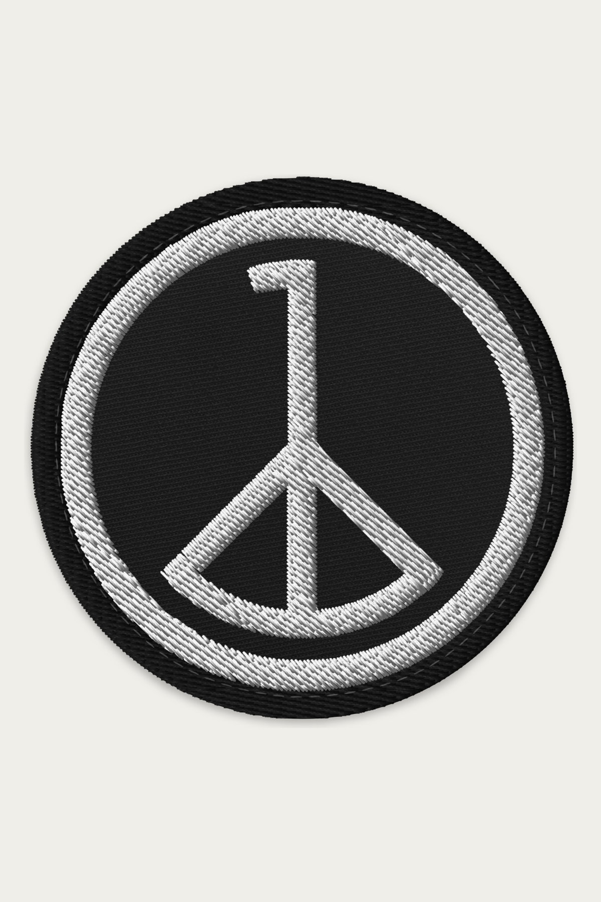 Embroidered Patch, Black by Andre Blunt, shown on a Cloud White ground