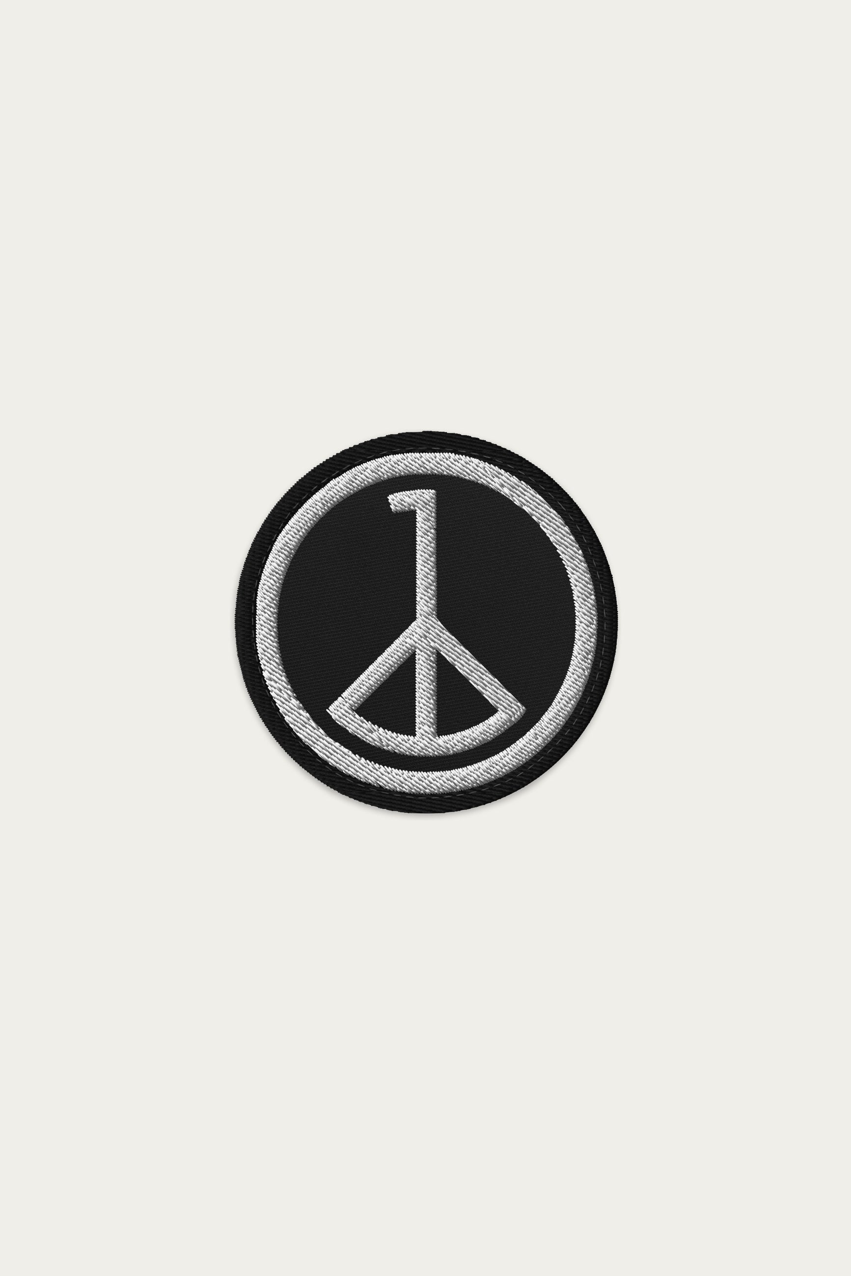 Andre Blunt embroidered wheel of peace patch in black