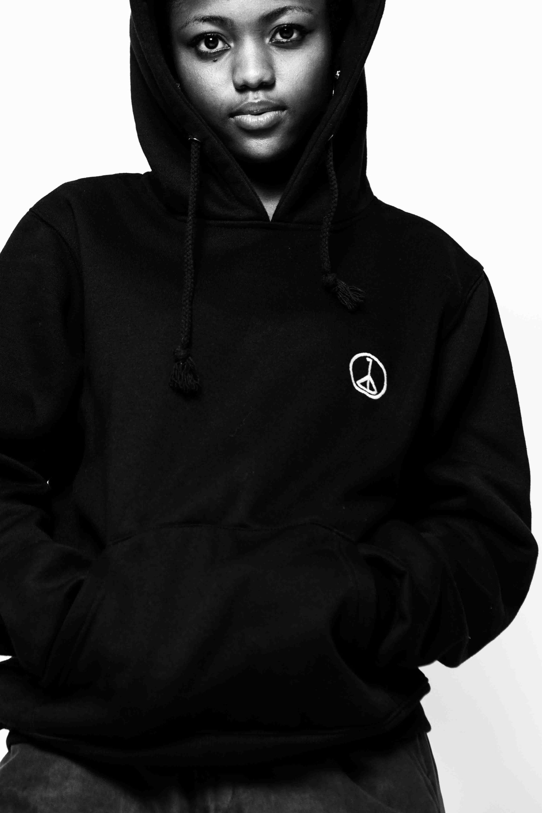 Andre Blunt black pullover hoodie, hood up, studio portrait