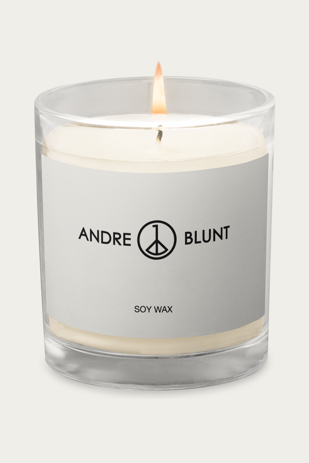 Soy Candle, Glass Jar by Andre Blunt, lit, on a Cloud White ground