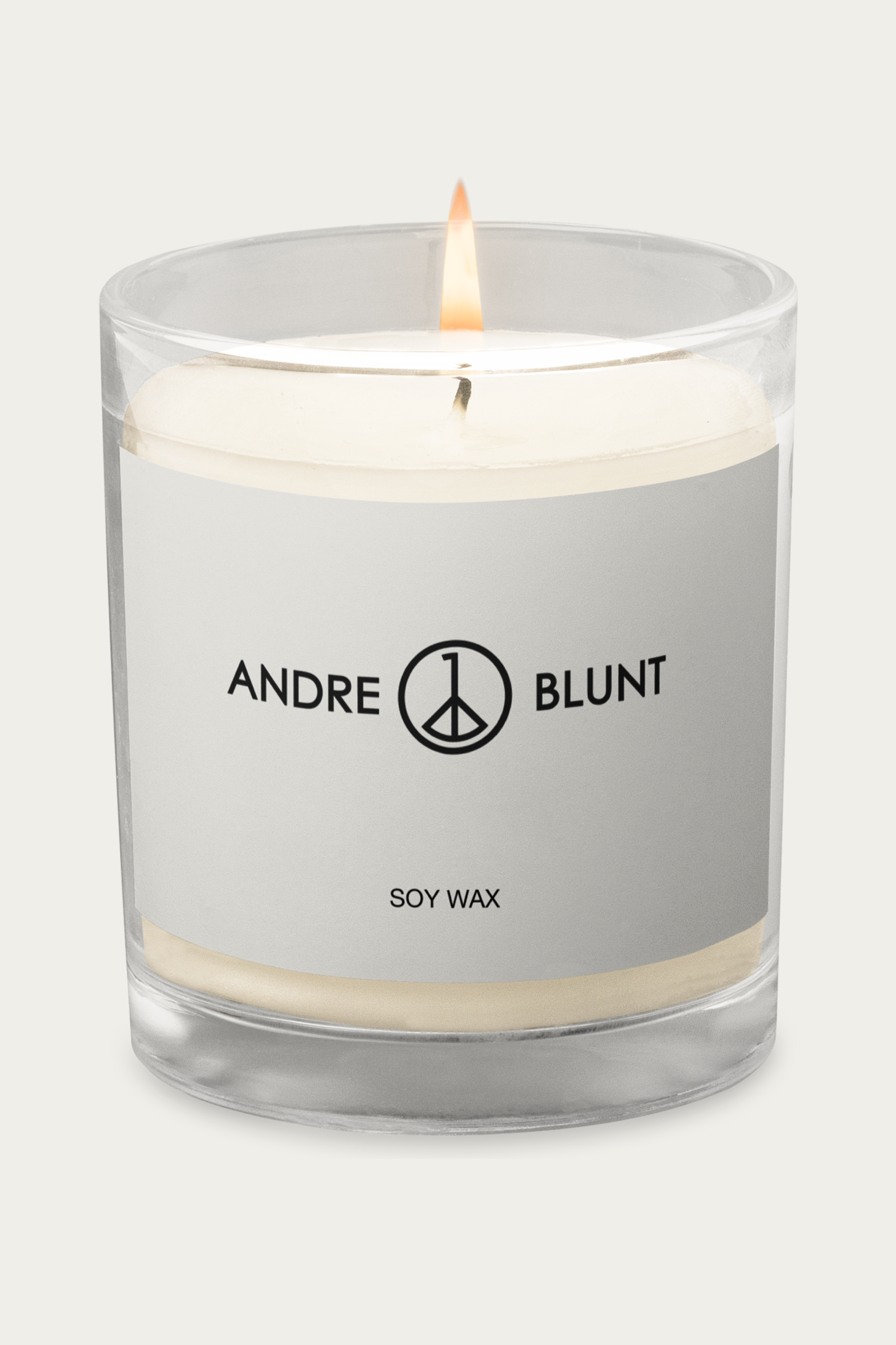 Soy Candle, Glass Jar by Andre Blunt, lit, on a Cloud White ground